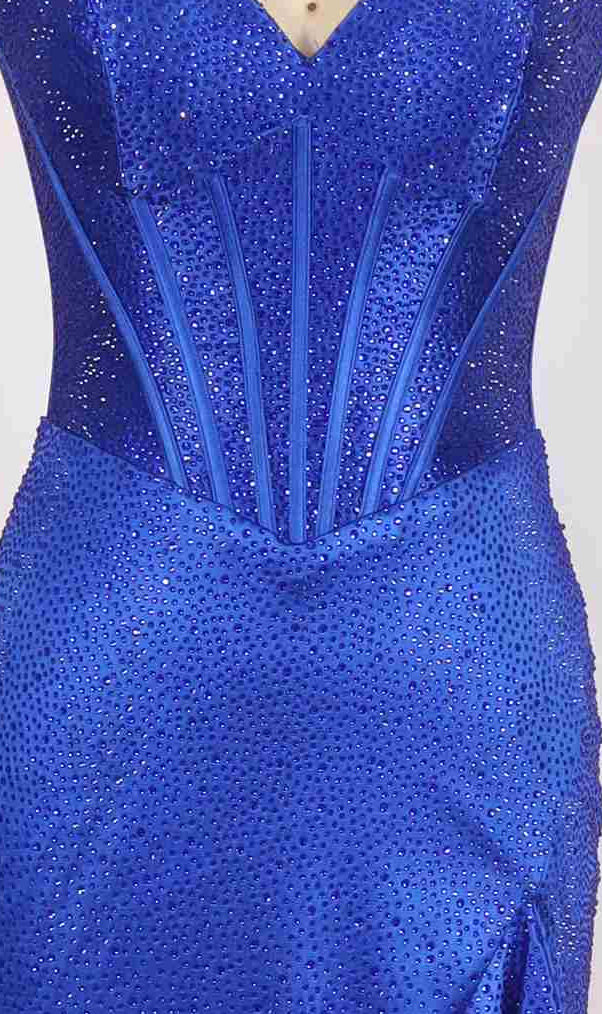 Close-up of the Long Prom Dress: PromGirl Exclusive 250214, a royal blue sequined strapless gown with a structured corset bodice and a hip-high slit.